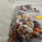 Colorful Polished Stones for $4 Plastic bag of assorted polished stones with a $4.00 price tag on a light-colored surface.