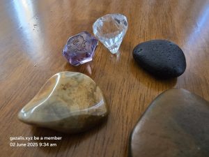 Stones and crystals on wood surface with text and date visible.
